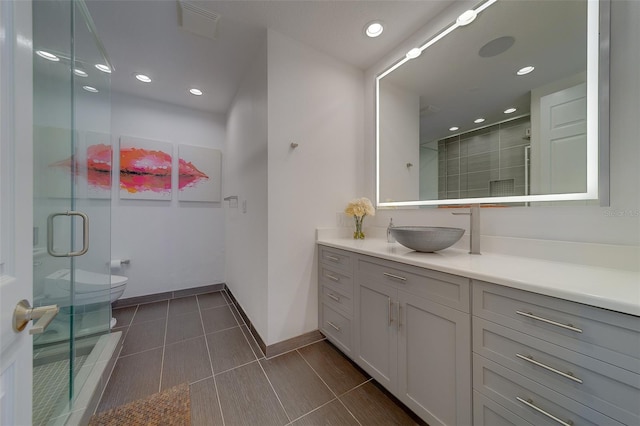 full bath with recessed lighting, toilet, a stall shower, vanity, and baseboards