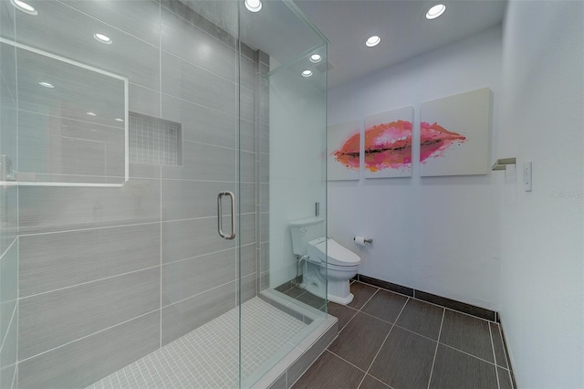 full bath featuring a stall shower, baseboards, toilet, tile patterned flooring, and recessed lighting