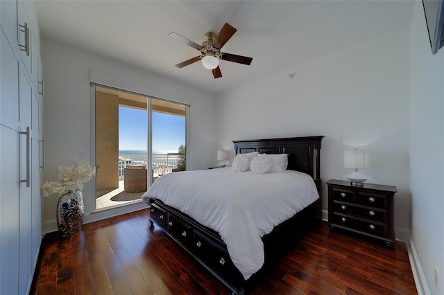 bedroom featuring access to exterior, baseboards, dark wood-style floors, and a ceiling fan