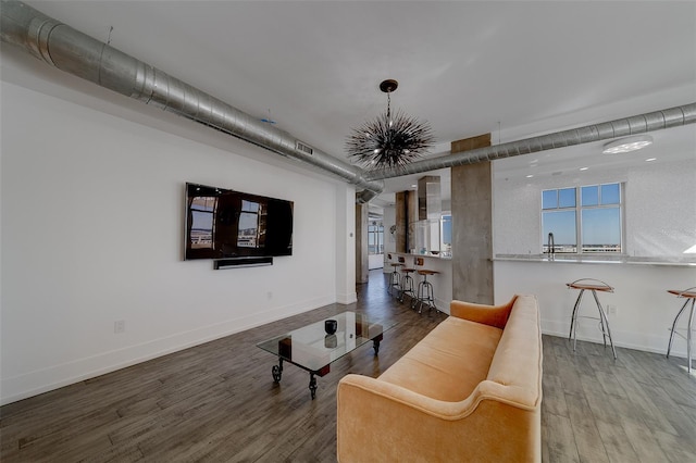 living area with baseboards and wood finished floors