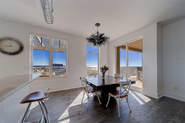 dining area with dark wood-style floors and baseboards