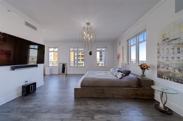 bedroom featuring crown molding, visible vents, and wood finished floors