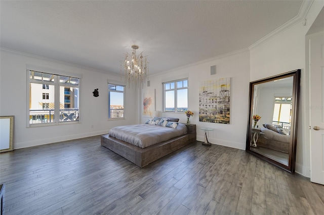 unfurnished bedroom featuring dark wood-style floors, crown molding, baseboards, and an inviting chandelier