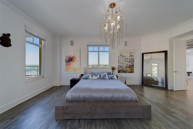 bedroom with baseboards, a notable chandelier, wood finished floors, and crown molding