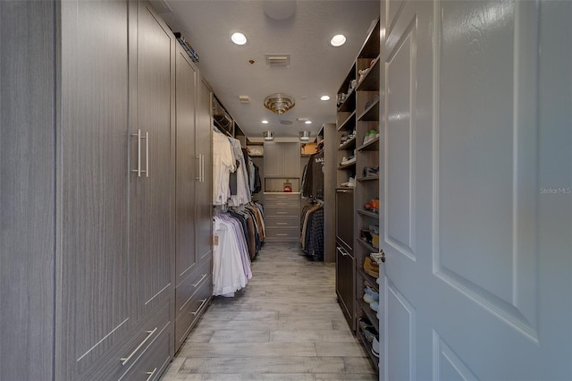 walk in closet featuring visible vents and light wood-style floors