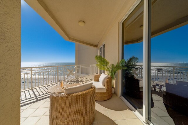 balcony with a water view and a beach view