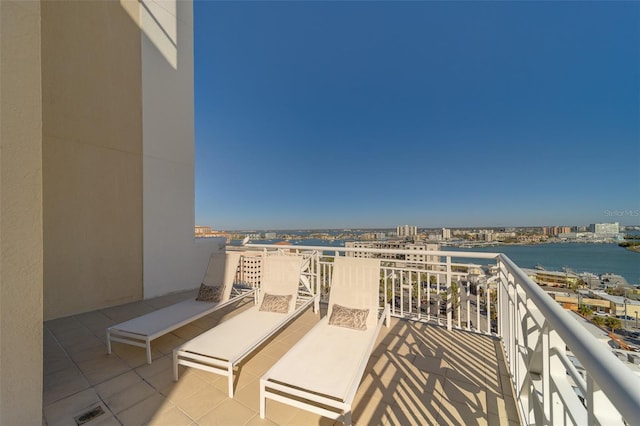 balcony with a water view and a city view