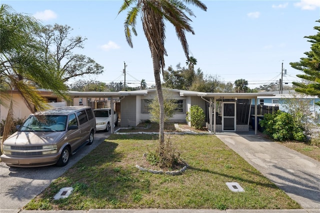 view of front of house featuring a front lawn and a carport