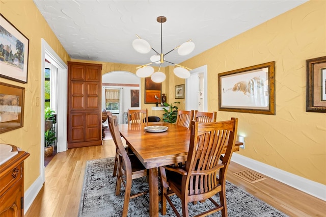 dining room featuring a chandelier and light wood-type flooring