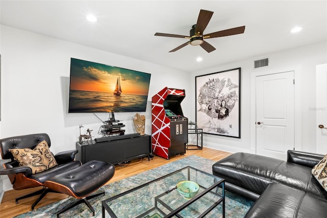 living room with wood-type flooring and ceiling fan