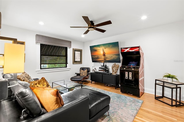 living room with ceiling fan and light wood-type flooring