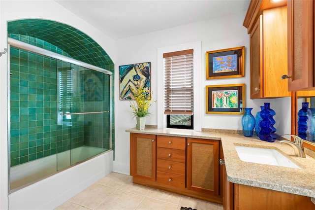 bathroom featuring vanity, tile patterned floors, and enclosed tub / shower combo