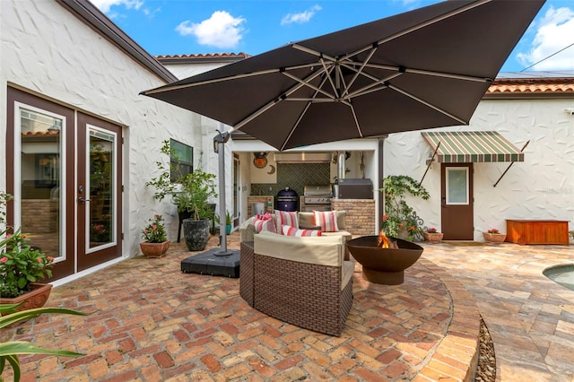 view of patio featuring french doors, an outdoor kitchen, and grilling area