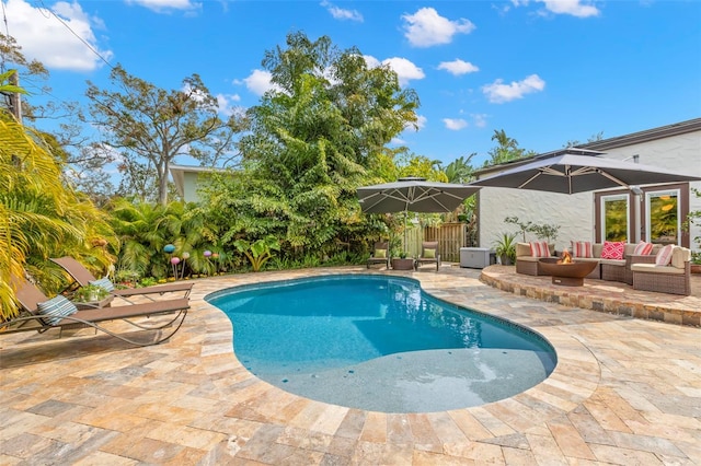 view of swimming pool with an outdoor living space and a patio