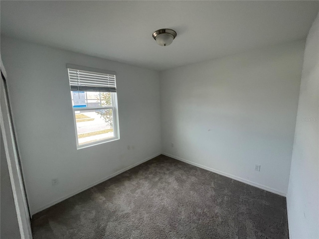 empty room with dark carpet