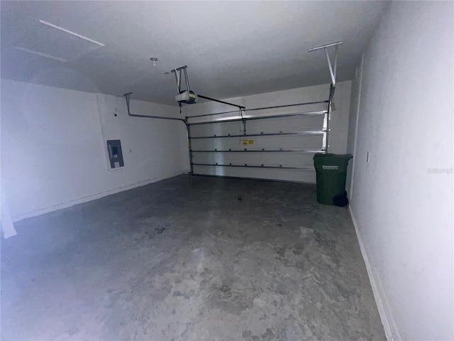 garage featuring a garage door opener and electric panel