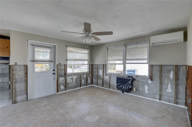 interior space featuring ceiling fan and a wall mounted air conditioner