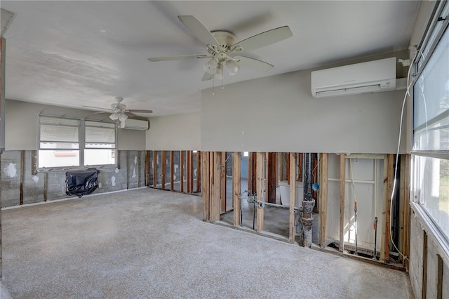 empty room featuring ceiling fan and a wall unit AC