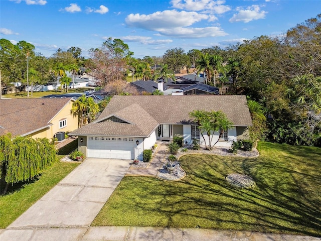 view of front of house with central AC, a garage, and a front yard