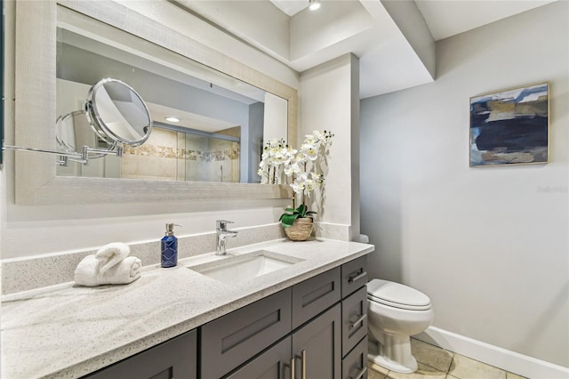 bathroom featuring vanity, toilet, and tile patterned flooring