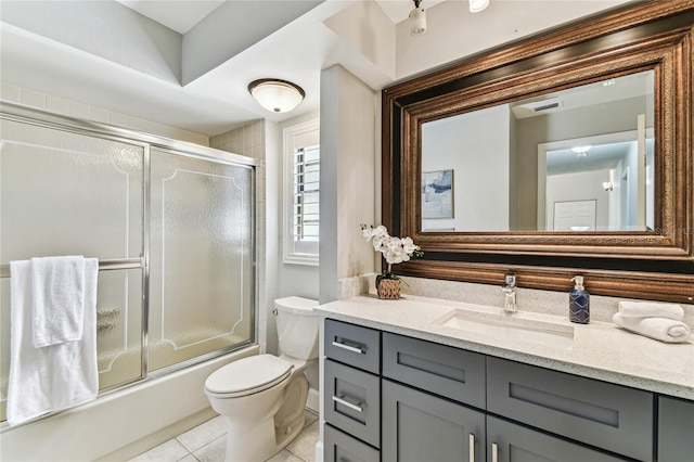 full bathroom with enclosed tub / shower combo, vanity, toilet, and tile patterned flooring