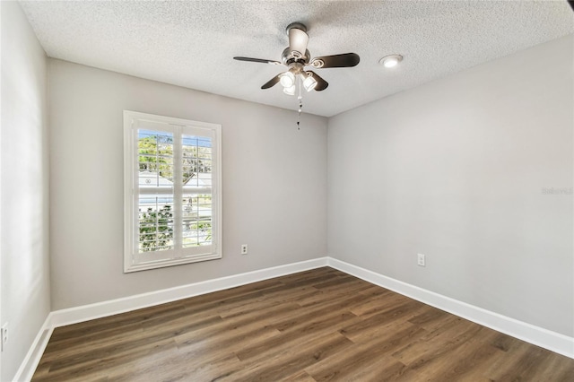 spare room with ceiling fan, dark hardwood / wood-style floors, and a textured ceiling