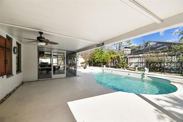 view of pool featuring pool water feature, glass enclosure, ceiling fan, and a patio area