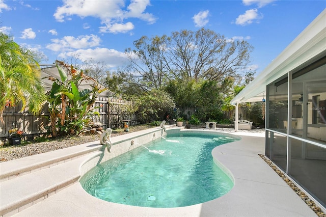 view of swimming pool with a patio area and a sunroom