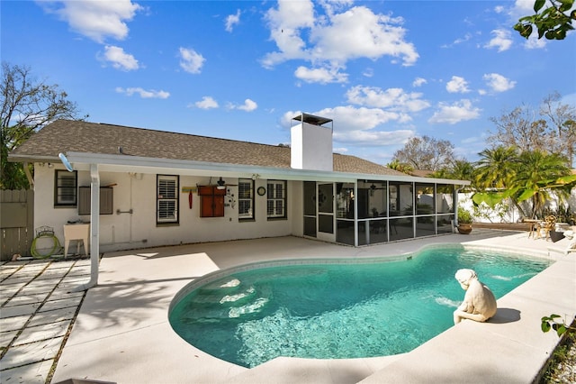 back of house featuring a sunroom and a patio area