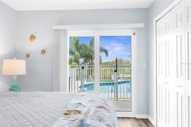 bedroom featuring access to exterior and light hardwood / wood-style floors