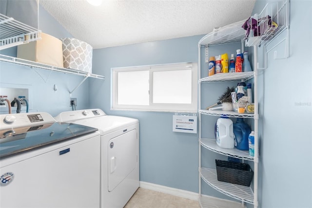 washroom with washer and dryer and a textured ceiling