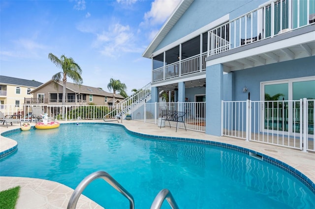 view of pool with ceiling fan and a patio area