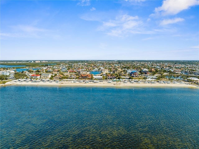 drone / aerial view with a water view and a beach view