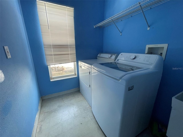 clothes washing area featuring washer and dryer