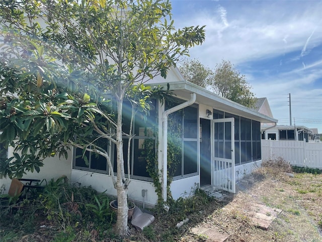 view of home's exterior with a sunroom