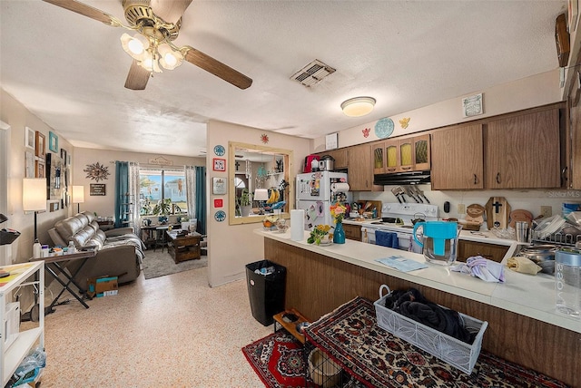 kitchen with ceiling fan, a textured ceiling, and white appliances