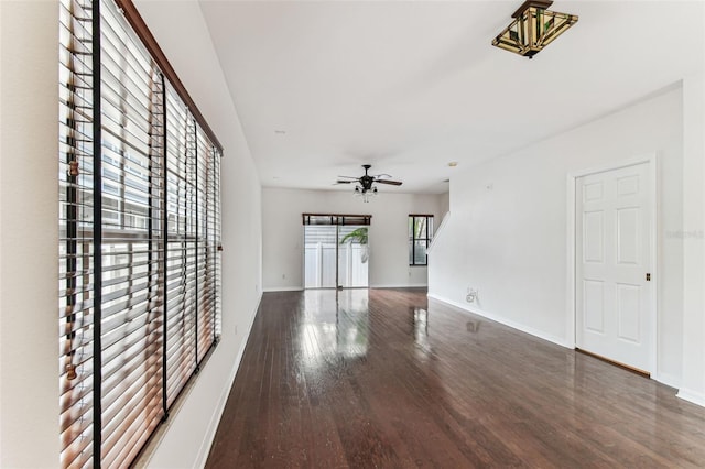 spare room with dark hardwood / wood-style flooring and ceiling fan