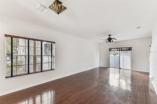 unfurnished living room with dark hardwood / wood-style floors and ceiling fan