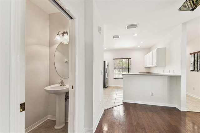 bathroom with wood-type flooring and sink