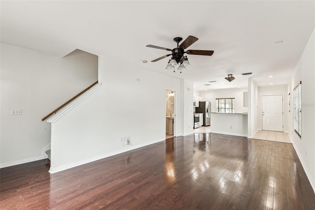 unfurnished living room featuring wood-type flooring and ceiling fan