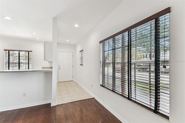 hallway with light hardwood / wood-style floors