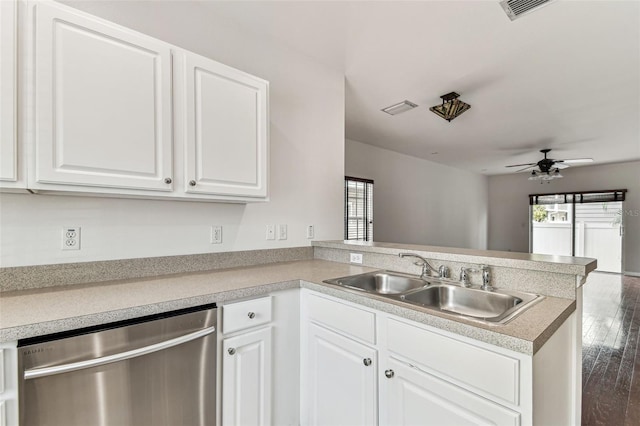 kitchen featuring sink, stainless steel dishwasher, kitchen peninsula, a healthy amount of sunlight, and white cabinets