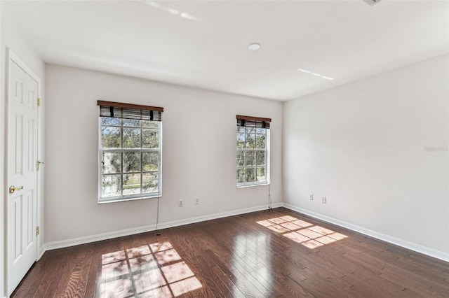 empty room featuring dark hardwood / wood-style flooring