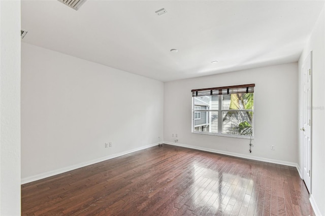 spare room with dark wood-type flooring