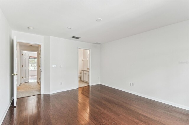 empty room with dark hardwood / wood-style flooring