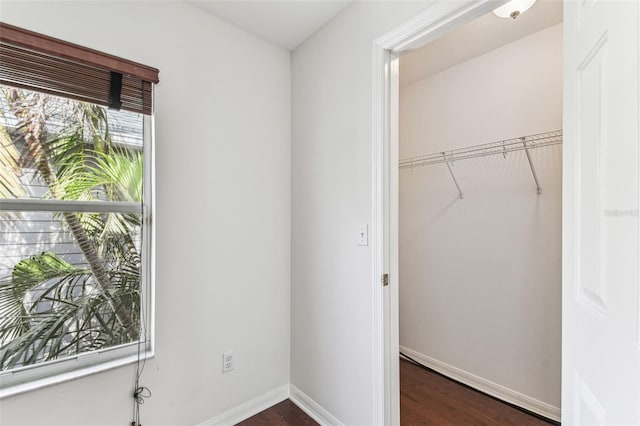 laundry area with dark wood-type flooring