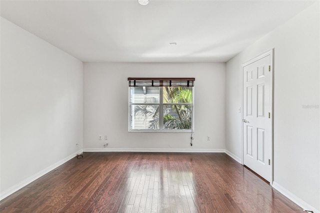 spare room featuring dark hardwood / wood-style flooring