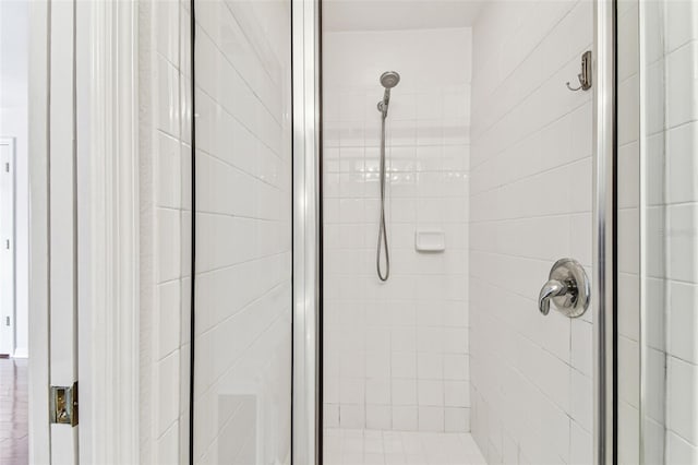 bathroom featuring a shower with shower door