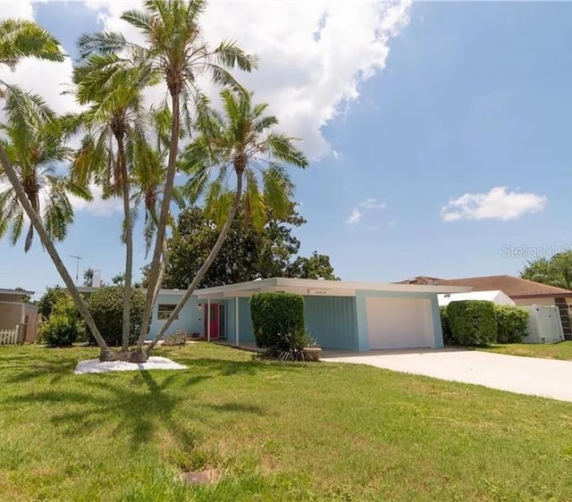 view of front of property with a garage and a front lawn