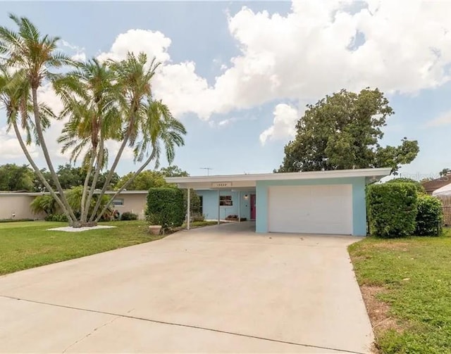 single story home featuring a garage and a front yard